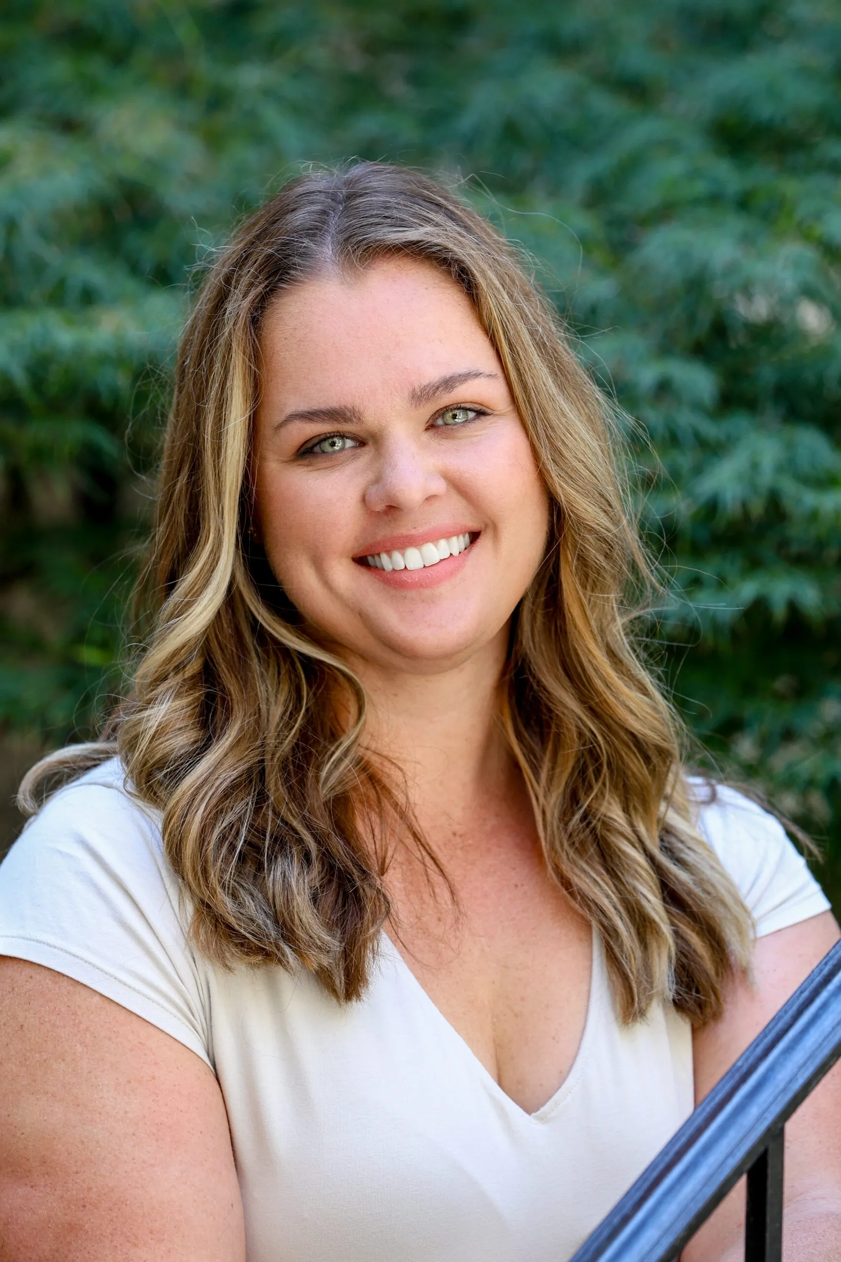 A woman with long hair and a white shirt.