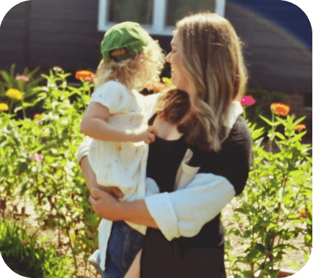 A woman holding a child in her arms.