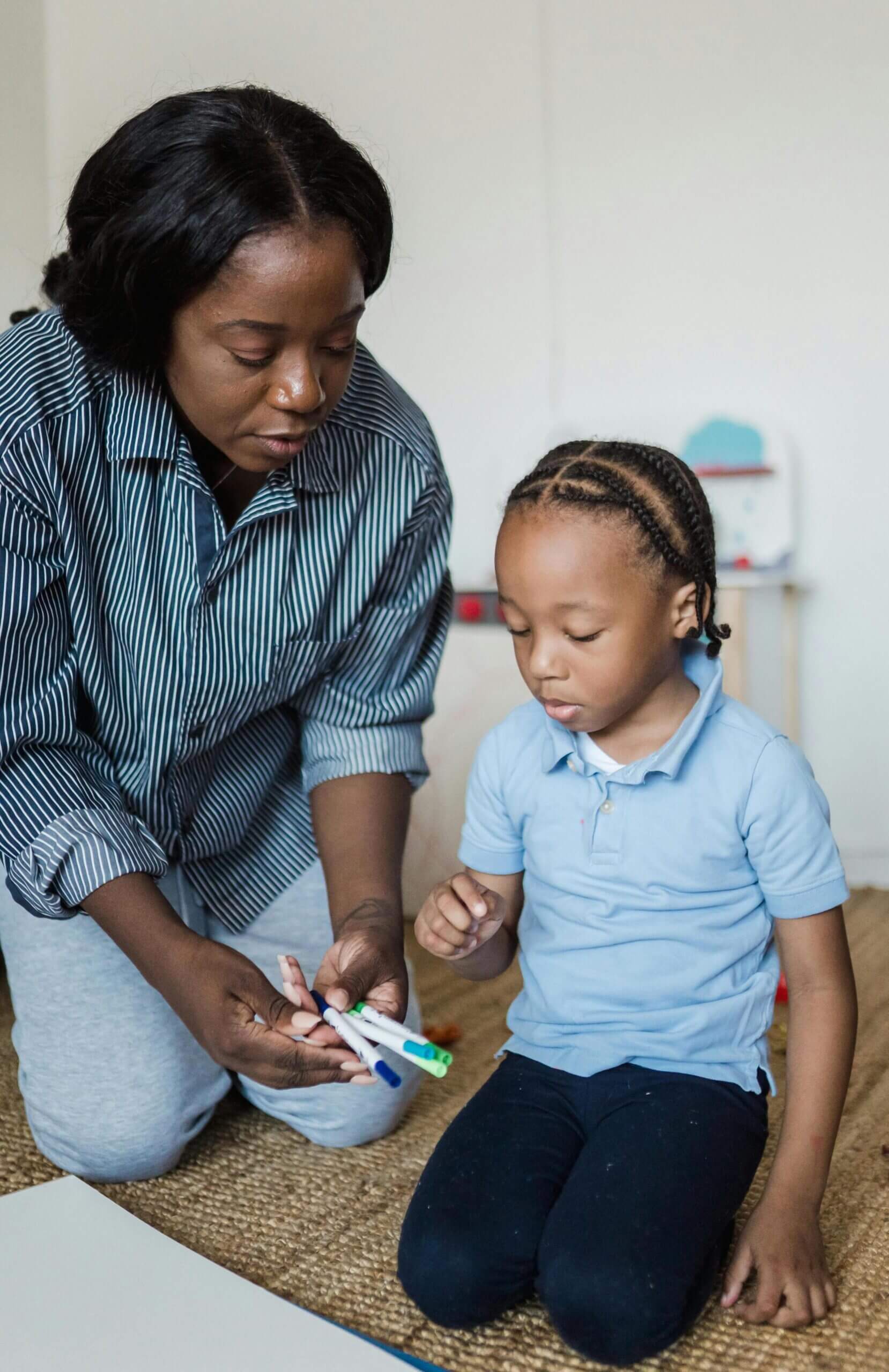 A woman and child brushing their teeth together.