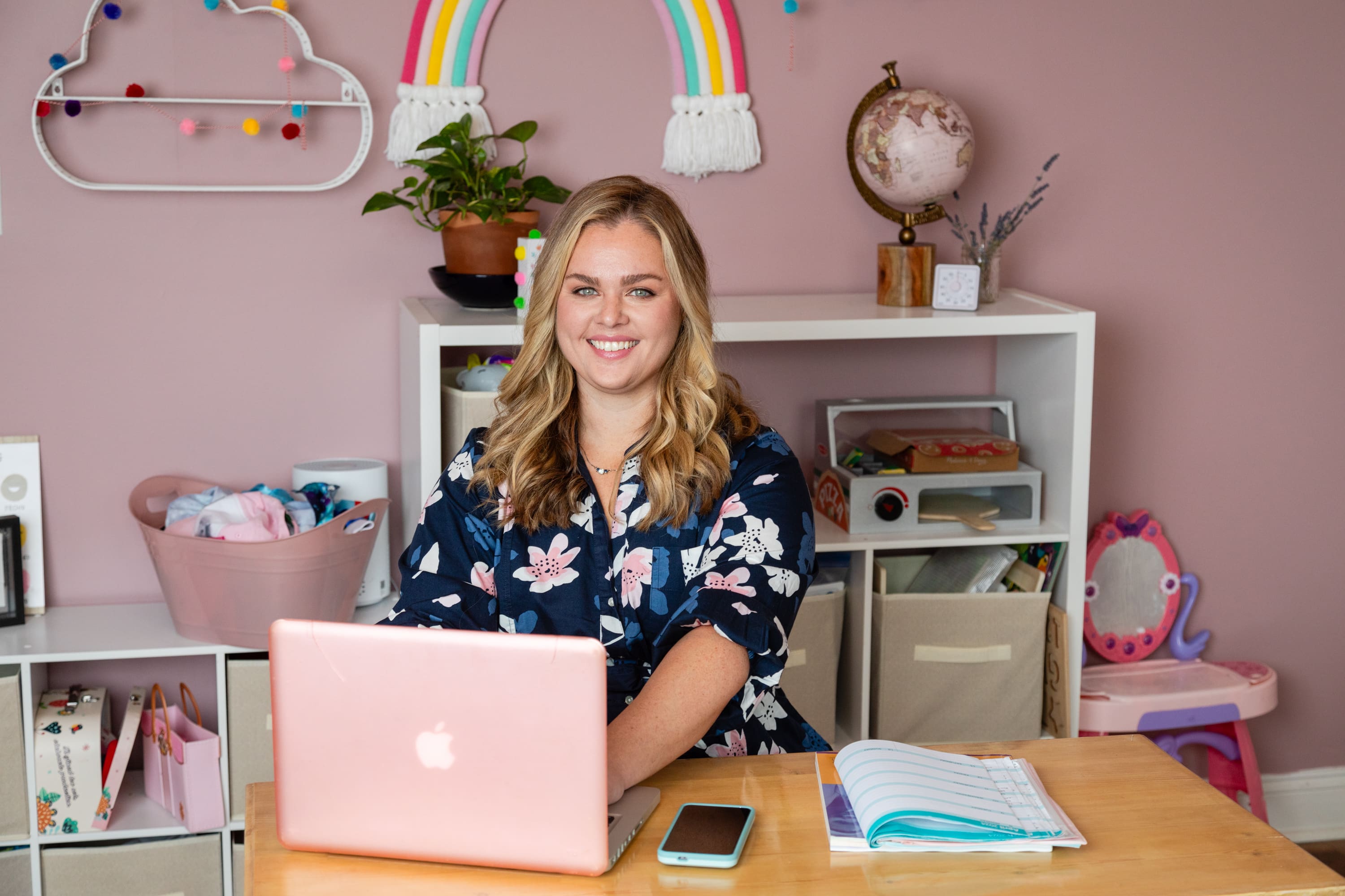 A woman sitting at a desk with a laptop.